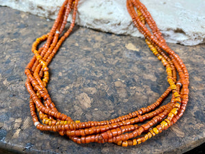 Our long tribal multistrand necklace is made with antique ceramic beads worn by the Bonda people of the Himalayas. This five strand red-brown-orange necklace is finished with a handmade sterling silver clasp and features sterling silver bead detailing. Measurements: 66 cm length