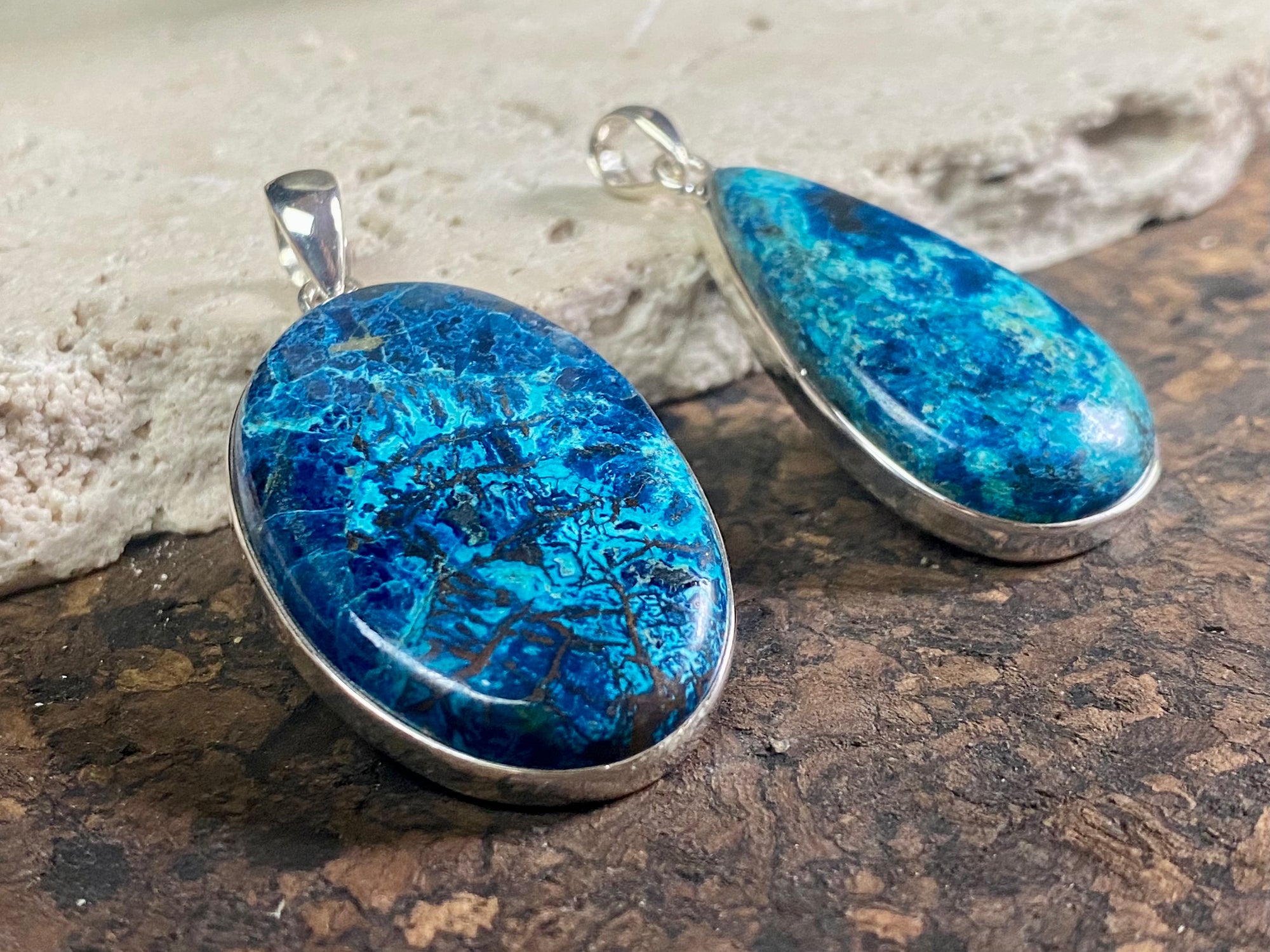 Unusual and striking azurite pendants. Set off by sterling silver bezels, topped by generous sized bails large enough to accommodate a thick chain or cord. If you're looking for something a little bit different, these pendants are stunning.