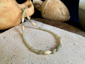 This unique choker features beautiful vintage beads from the Kashgar collection - blue green turquoise centre bead, Ethiopian opal, Bone beads from Burma, Pale green chrysoprase beads, Green serpentine tube beads from Afghanistan and 925 sterling silver detailing and lobster clasp. Length 40.5 cm