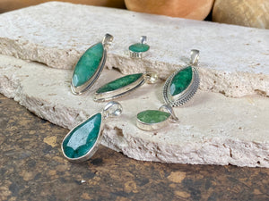 Six lush natural emerald pendants featuring large facet cut stones set in sterling silver. All are set with generous bails to fit on even the largest of chains, torcs or cords. Ranging in length from 6 cm to 2.8 cm
