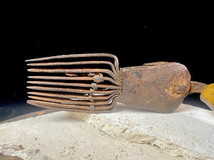 Used for the manual tamping down of carpet threads during the weaving process on a hand loom. Heavy iron with a wood handle. 19th century or older. Afghanistan.  Measurements: length 26 cm, width 6.5 cm, height 10 cm