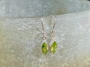 Beautiful peridot earrings featuring gem quality facet cut peridot stones in three shapes, teardrop, oval or leaf. A sterling silver mount and hook completes the look. These earrings are open at the back to allow light to shine through the stones. Around 3 cm length including hook