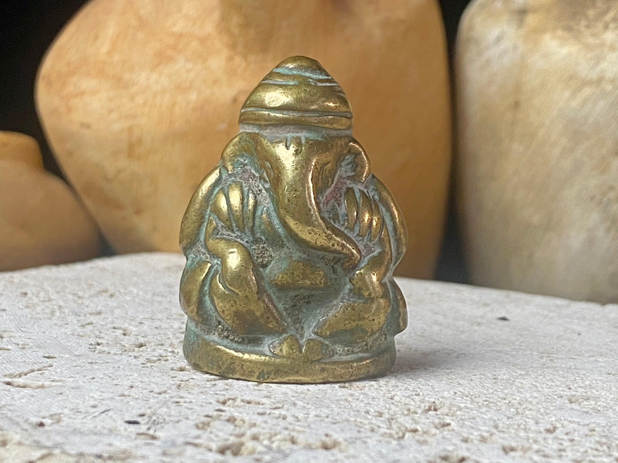 Pocket Ganesh statue cast in brass, with both hands resting on his knees. This is a beautiful compact casting, ideally suited to a small altar or display, or for carrying in a pocket or bag. Our Ganesh has some age, and is a vintage piece, approximately 40 years old or older. Height 4 cm.