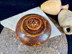 A beautiful low oval lidded bowl or box, traditionally called an opium pot because of its shape. Crafted from wood, then hand painted with hunting scenes. Hand made in Rajasthan, India. Measurements: diameter 14.5 cm, height 7 cm.