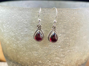 Elegant teardrop shaped earrings with a beautifully detailed bezel to show off the natural beauty of the cabochon stones. Sterling silver hooks complete the look. Our earrings are open-backed to allow natural light to show through. Length including hook 2.7 cm