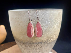 The most beautiful rhodochrosite we've ever seen. Every piece tells a story, and all earring pairs feature perfectly matched stones set in sterling silver bezels. Finished with sterling silver hooks.