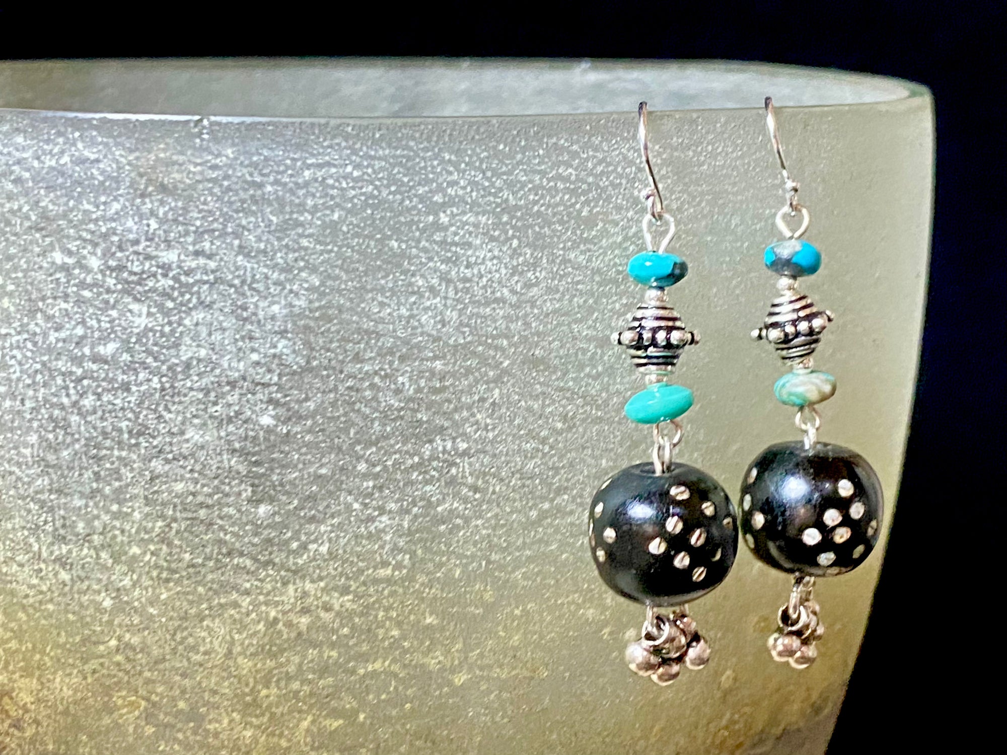 These statement earrings were created from vintage Yemeni black wood beads inlaid with silver. They are finished with Arizona turquoise and sterling silver handmade beads & hooks. A one-off earring design that's light and easy to wear. Length 5 cm including hook, and the inlay beads are approximately 12 mm in length.