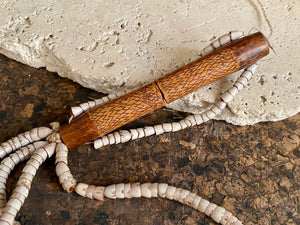 This is a vintage wood sewing needle case from northern Thailand, from the Ahka tribe. This beautiful, old and rare vintage piece is highly decorated and made from bamboo, etched, stained with red betel juice and finished with a long fringe of Jacob's tears. Length 24.5 cm with fringe, length of tube 9 cm