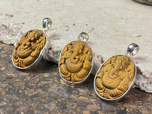 Hand carved Ganesh pendants, tigers eye with sterling silver mount and bail.  Dimensions 3.7 x 1.7 x 0.7 cm