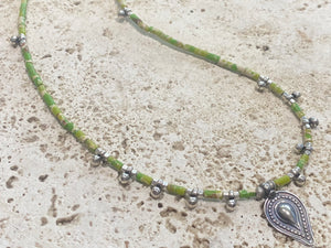 This very pretty necklace is made from tube cut imperial green jasper, highlighted with traditional handmade sterling silver Rajasthani ball beads and a tribal pendant. Finished with sterling silver findings and hook clasp. The pendant represents the shiva lingam/yoni. Length 40.5 cm