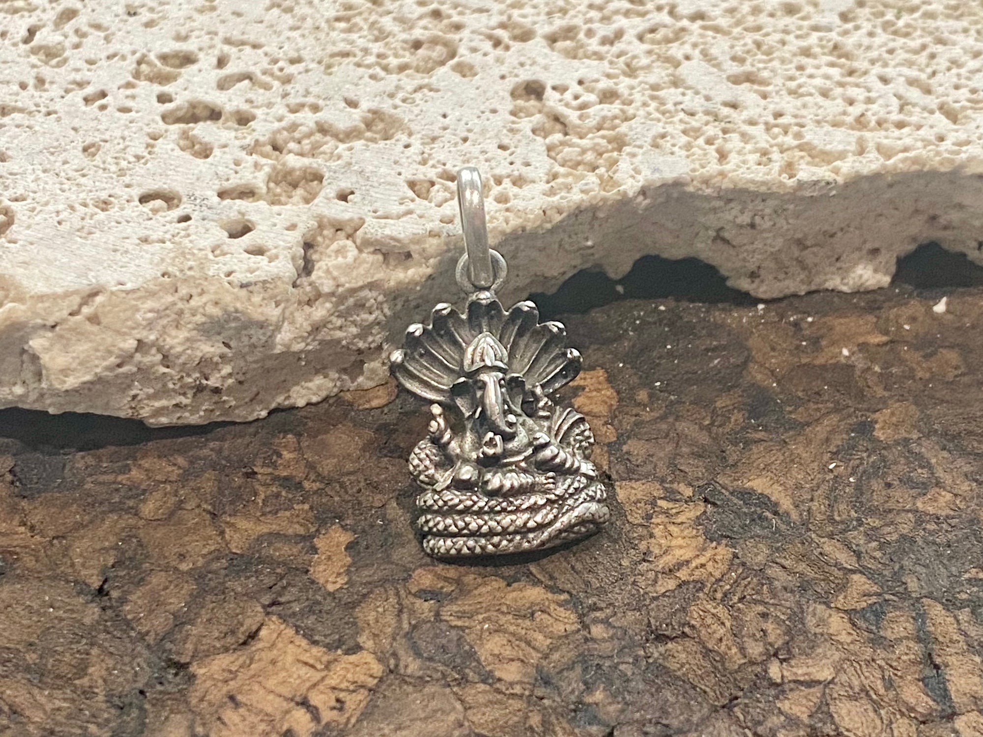 Detailed sterling silver pendant featuring Lord Ganesha cast in exquisite detail. A generous bail allows this pendant to be worn on a large chain or cord. This is a unisex pendant. Sterling silver, from India Measurements: 1.8 cm height including bail, width 1.2 cm