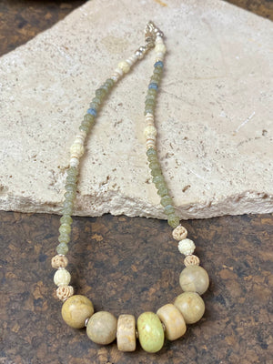 Tribally inspired stone necklace featuring prehnite, jasper, lotus root, carved white coral , glass and sterling silver. Length 39.5 cm