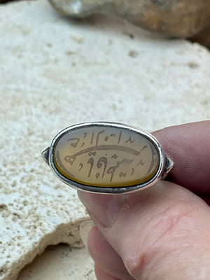 Afghani ring features an antique honey-coloured engraved carnelian prayer plaque set into a new silver band. Sits high on the finger and is a statement piece. High grade or sterling silver has been used to make the ring band. Men or women's ring. Measurements: Carnelian 2.4 x 1.4 cm, inner diameter 19.75 mm | Size 10