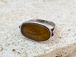 Afghani ring features an antique honey-coloured engraved carnelian prayer plaque set into a new silver band. Sits high on the finger and is a statement piece. High grade or sterling silver has been used to make the ring band. Men or women's ring. Measurements: Carnelian 2.4 x 1.4 cm, inner diameter 19.75 mm | Size 10