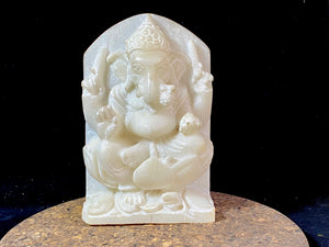 Hand carved marble stone statue of Ganesh. Our Ganesh sits on a lotus pedestal, while his mouse sits at his feet. One of his right hands is upraised in the gesture of protection, while the other holds his favourite ladoo sweet. Measurements: 22 cm high, 14 cm wide, 6 cm depth