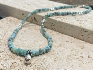 Light blue blue necklace of tumbled, facet cut graduated larimar, highlighted with Rajasthani silver beads and a beautiful central drop pendant. Finished with sterling silver findings and hook clasp. and a hook clasp. Measurements: 46 cm (18") length