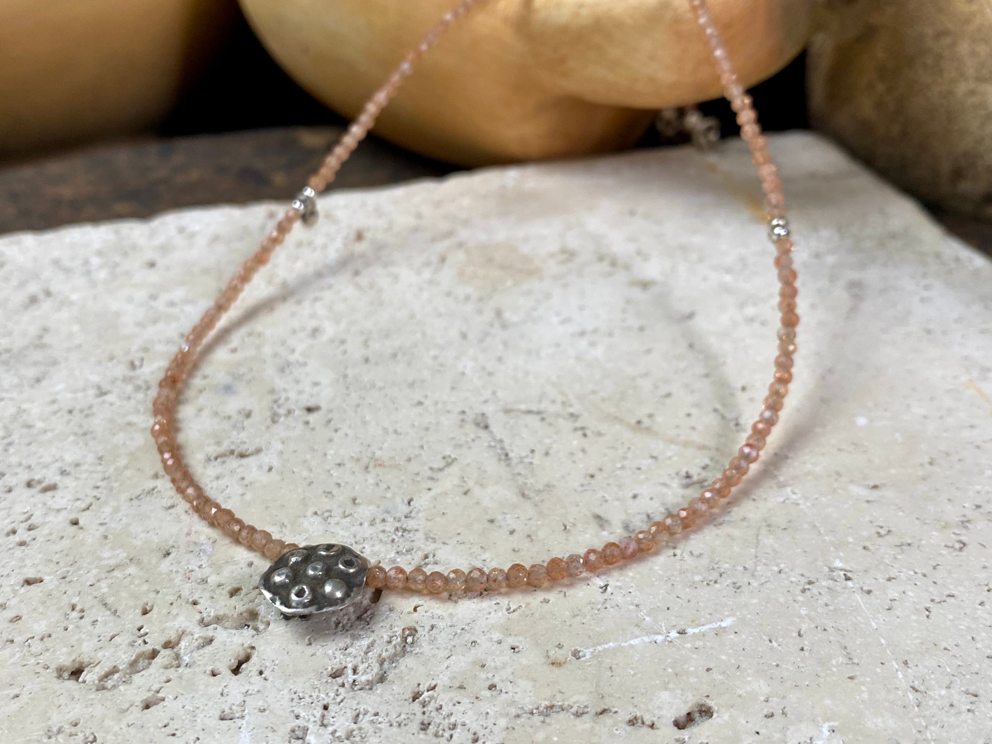 Natural clear pink/orange sunstone bead necklace with a beautiful old Indian silver pendant as the centrepiece. Silver bead detailing and a silver lobster clasp complete the look. Length 41.8 cm