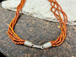 Our long tribal multistrand necklace is made with antique ceramic beads worn by the Bonda people of the Himalayas. This five strand red-brown-orange necklace is finished with a handmade sterling silver clasp and features sterling silver bead detailing. Measurements: 66 cm length