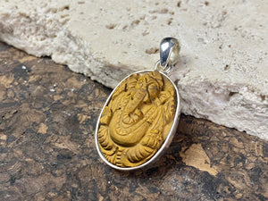 Hand carved Ganesh pendants, tigers eye with sterling silver mount and bail.  Dimensions 3.7 x 1.7 x 0.7 cm