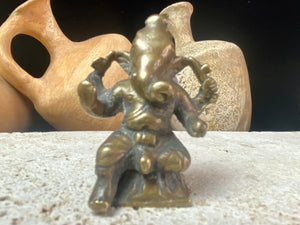 This exquisite mini Ganesh statue features fine, elegant features, and a face softened by many years of rubbing and worship. A beautiful piece. Approximately 100 years old, early 20th century, India, brass alloy.  Measurements: height 6.5 cm, width 3.2 cm, depth 2.5 cm