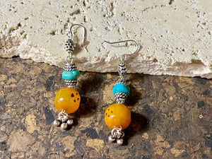 These exotic earrings were created from vintage copal amber beads topped with Arizona turquoise and handmade sterling silver beads, finished with sterling silver hooks.These are a one-off earring design that are very light and easy to wear. Length 5.8 cm including hook