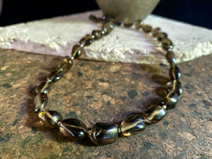 This simple necklace is crafted from high quality, tumbled and naturally dark smokey quartz stone and highlighted with sterling silver spacer beads. Finished with sterling silver ends. Measurements: Total length including clasp 50.5 cm