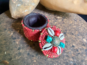 Sikkim ceramic bead work adorning a small trinket box. Soft fabric interior. Measurements: 6 cm diameter, 6 cm height.