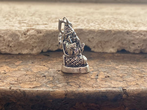 Sterling silver pendant featuring Lord Ganesha portrayed in 3D, this heavy silver charm pendant can be viewed in 3 dimensions, with his back as complete and as detailed as his front. A generous bail allows this pendant to be worn on a large chain or cord. he can even sit upright as the smallest of ganesh statues. This is a unisex pendant or statue. Sterling silver. Measurements: 3 cm height including bail