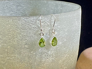 Beautiful peridot earrings featuring gem quality facet cut peridot stones in three shapes, teardrop, oval or leaf. A sterling silver mount and hook completes the look. These earrings are open at the back to allow light to shine through the stones. Around 3 cm length including hook