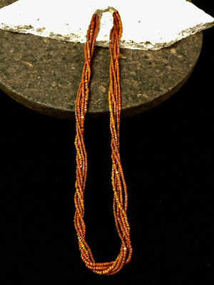 Our long tribal multistrand necklace is made with antique ceramic beads worn by the Bonda people of the Himalayas. This five strand red-brown-orange necklace is finished with a handmade sterling silver clasp and features sterling silver bead detailing. Measurements: 66 cm length