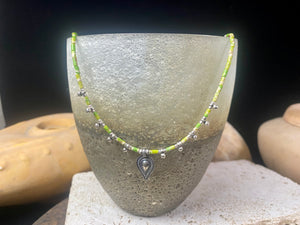 This very pretty necklace is made from tube cut imperial green jasper, highlighted with traditional handmade sterling silver Rajasthani ball beads and a tribal pendant. Finished with sterling silver findings and hook clasp. The pendant represents the shiva lingam/yoni. Length 40.5 cm