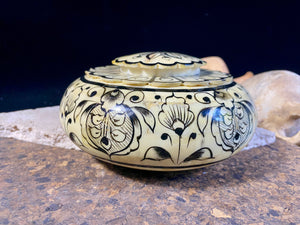 A beautiful low oval lidded bowl or box, traditionally called an opium pot because of its shape. Crafted from hand shaped panels of camel bone over wood, then hand painted. Hand made in Rajasthan, India. Measurements: diameter 15.5 cm, height 6.5 cm.