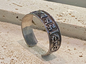 Sterling silver Buddhist Om Manu Padme Hum bracelet. This is a large and substantial men's silver cuff  This beloved Buddhist mantra translates to “hail, jewel in the lotus” and is the prayer of the Compassionate Buddha Avelokitsvara.