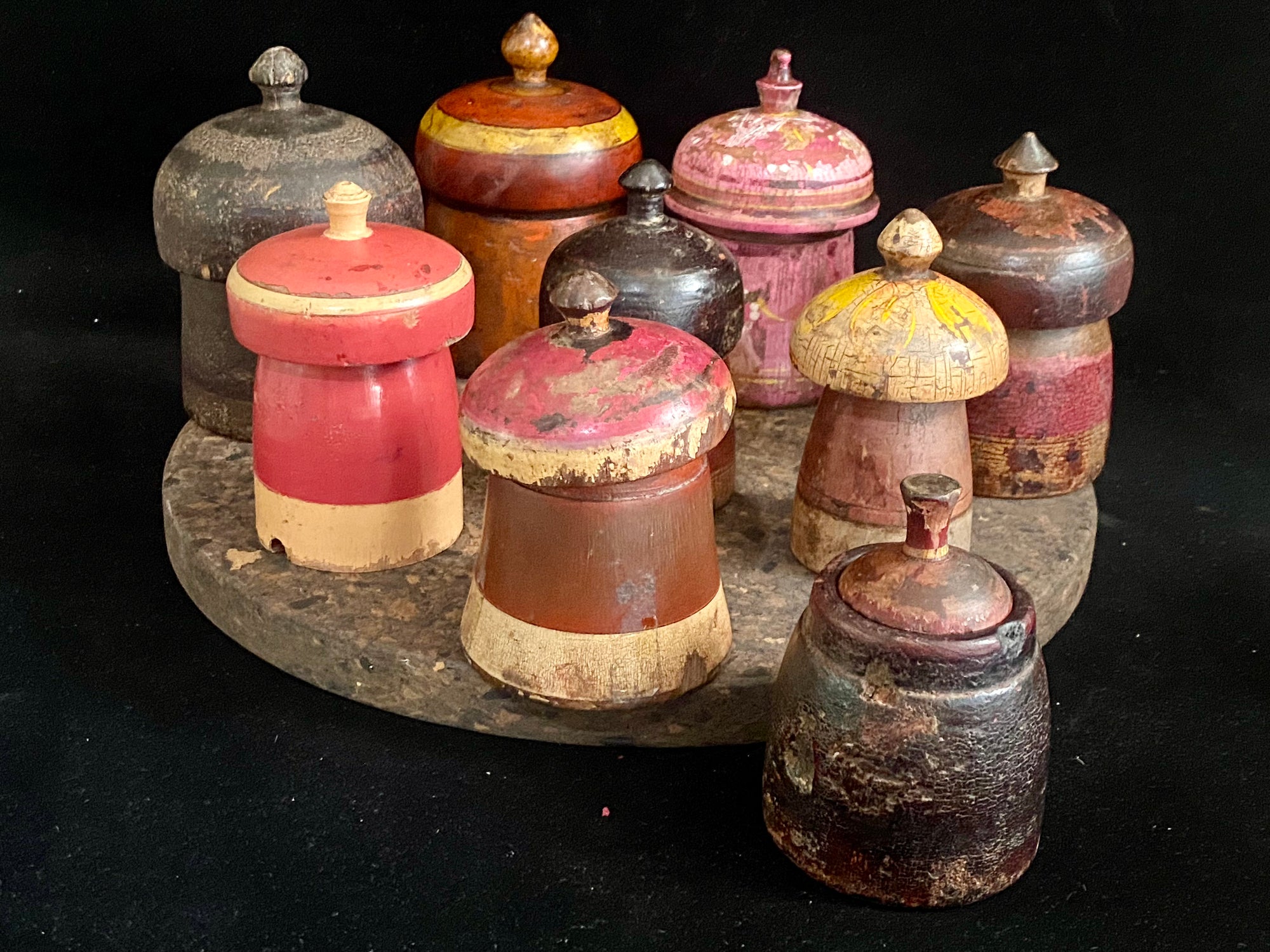 Antique small tikka pots. Hand carved teak, lacquer paint. Approx 50-90 years old. Assorted shapes, sizes and colours. Height approximately 9-12, diameter 6-8 cm