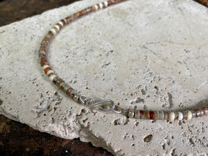 This unique necklace is made from heshi amazonite quartz druzy beads, highlighted with Kachin Burmese shell beads and a pendant made from unpolished onyx. Finished with sterling silver findings and hook clasp. Our necklace will look great on either men or women. Measurements: length including clasp 43.5 cm (17”)