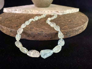 Natural pale blue aquamarine bead necklace featuring a magnificent centre bead and tiny silver bead detailing. Sterling silver findings. The aquamarine beads are matched, graduated, 100% natural and facet cut. They are a very light blue with a colour that changes depending on the angle viewed. 44.5 cm length