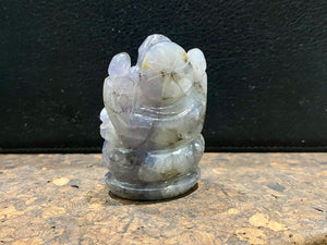 Hand carved from a solid chunk of iolite crystal, our Ganesha statue has a very contemporary feel. Ganesh is the lord of wisdom, remover of obstacles, patron of the the arts and new beginnings. Keeps unwanted influences from your door. Measurements: 5 cm height, width at base 3.5 cm