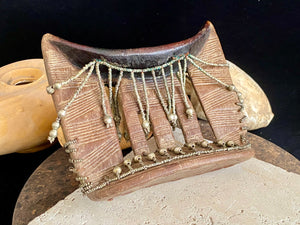 Kambatta wood headrest, Ethiopia. Early 1900's. Heavily carved and beaded. Dark patina and smooth wear on this piece are appropriate to its age. Measurements: height 16 cm (7"), width 18 cm