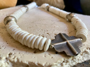 A mid-length white howlite and silver necklace crafted crafted from natural heshi cut beads, with a handmade sterling silver cross centrepiece and antique Indian silver beads. Finished with sterling silver ends and hook clasp. Total length 51.8 cm, pendant 2.5 cm diameter