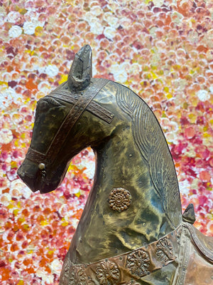 Antique Indian rocking horse. Covered entirely in sheets of embossed brass and copper sheet with floral and ornamental plaques, strap work and highly embossed decoration. Hardwood Early 20th century, southern India. Measurements: height to ear 52 cm, length 40.5 cm, width 13.5 cm.