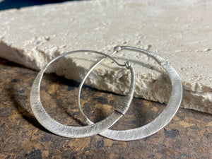 Beautiful hand beaten sterling silver hoops with wrapped silver wire detailing. Waziri, from Afghanistan. Measurements: outside diameter of hoop approximately 4.6 cm