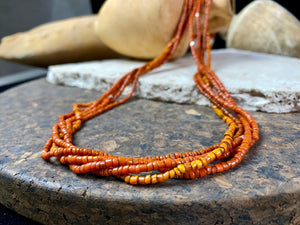 Our long tribal multistrand necklace is made with antique ceramic beads worn by the Bonda people of the Himalayas. This five strand red-brown-orange necklace is finished with a handmade sterling silver clasp and features sterling silver bead detailing. Measurements: 66 cm length