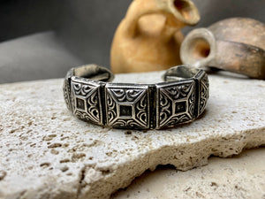 A modern interpretation of an antique style of bracelet, this fine cuff is hand crafted from sterling silver by Rajasthani silversmiths. Exquisitely detailed, the oxidised finish shows off the workmanship beautifully. There is some small room for movement in this cuff, and it is designed to fit an average sized wrist.  Measurements: Inside opening is 6.5 cm, with room for expansion or contraction