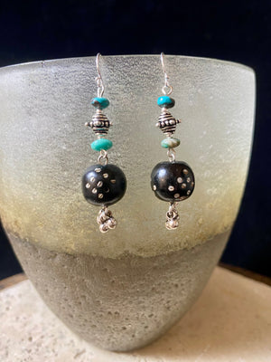 These statement earrings were created from vintage Yemeni black wood beads inlaid with silver. They are finished with Arizona turquoise and sterling silver handmade beads & hooks. A one-off earring design that's light and easy to wear. Length 5 cm including hook, and the inlay beads are approximately 12 mm in length.