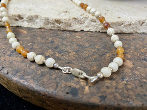 Our unique statement necklace features beautiful vintage beads from the Kashgar collection - turquoise centre bead, jasper beads from the Philippines, howlite beads, buffalo horn beads and 925 sterling silver detailing and lobster clasp. Length 45 cm.