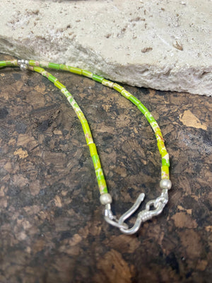 This very pretty necklace is made from tube cut imperial green jasper, highlighted with traditional handmade sterling silver Rajasthani ball beads and a tribal pendant. Finished with sterling silver findings and hook clasp. The pendant represents the shiva lingam/yoni. Length 40.5 cm