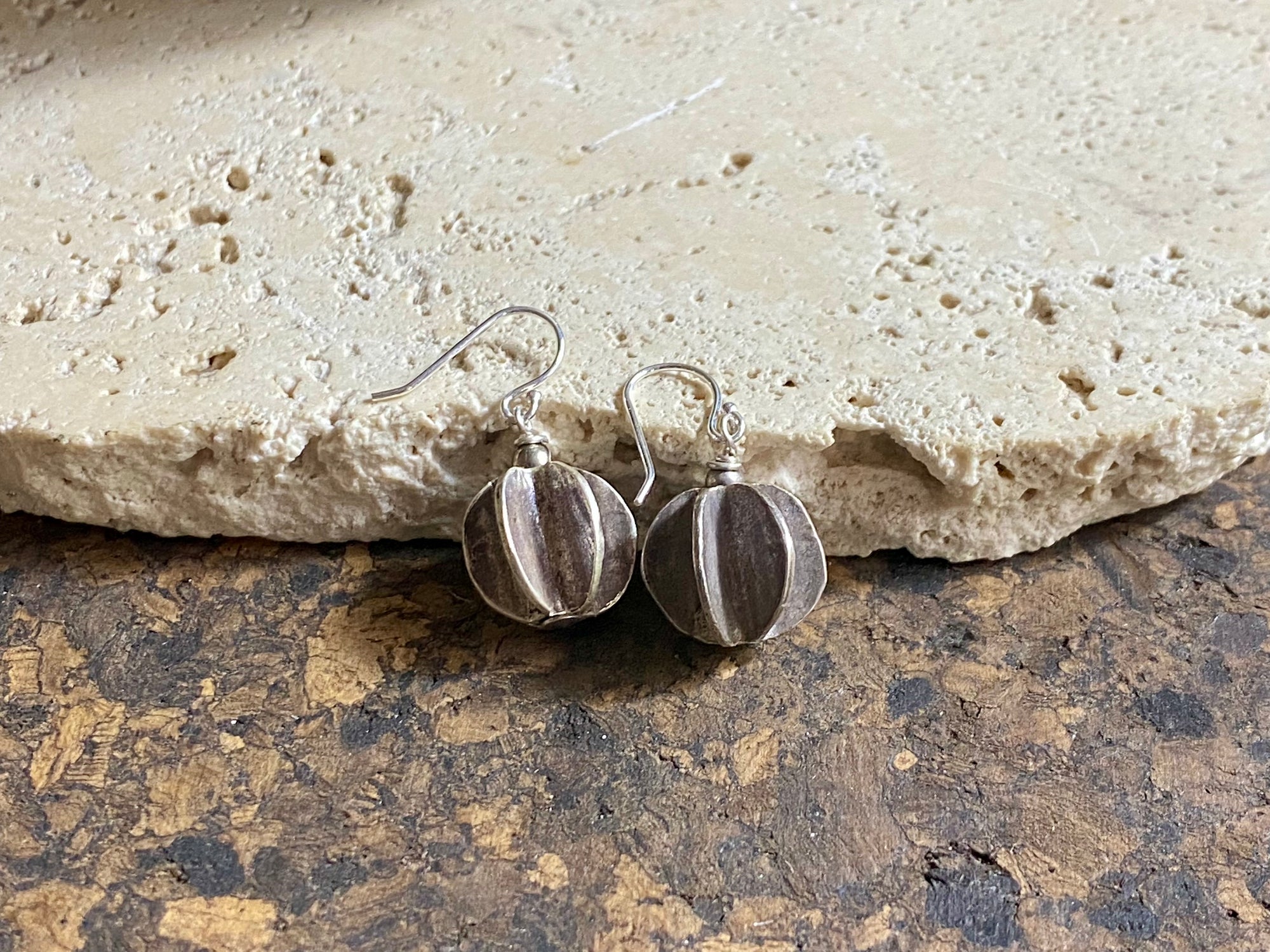 One of our most popular earring styles, these tribal look earrings are made with Karen hill tribe pumpkin charms of high grade silver (95%) and finished with sterling silver hooks. Measurements: charm 1.5 cm diameter, earring length 3 cm including hook