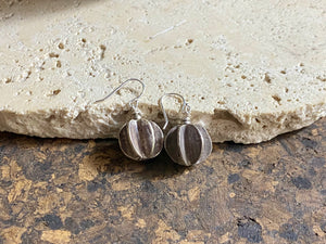 One of our most popular earring styles, these tribal look earrings are made with Karen hill tribe pumpkin charms of high grade silver (95%) and finished with sterling silver hooks. Measurements: charm 1.5 cm diameter, earring length 3 cm including hook