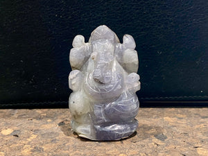 Hand carved from a solid chunk of iolite crystal, our Ganesha statue has a very contemporary feel. Ganesh is the lord of wisdom, remover of obstacles, patron of the the arts and new beginnings. Keeps unwanted influences from your door. Measurements: 5 cm height, width at base 3.5 cm