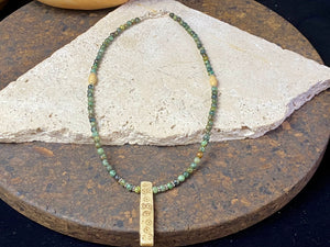 Tribal inspired necklace made from African jasper, highlighted with an antique Naga bone pendant and Kachin antique bone beads. Sterling silver findings and hook clasp. This unisex necklace is 45.5 cm (18") in length, pendant 5 cm (2") length.